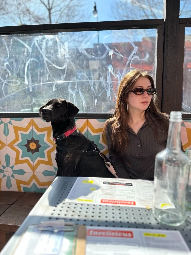 Kona and Alexandra at an outdoor taco spot, sunlit and calm